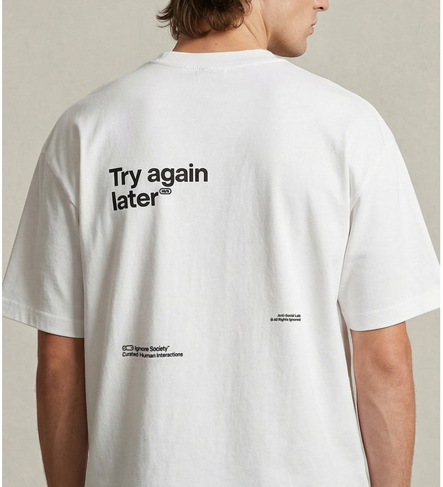 Person wearing a white t-shirt with text on the back against a neutral background