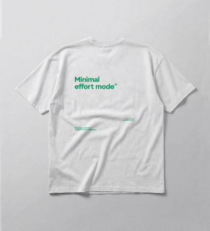 White t-shirt with green text 'Minimal effort mode' on a light gray background