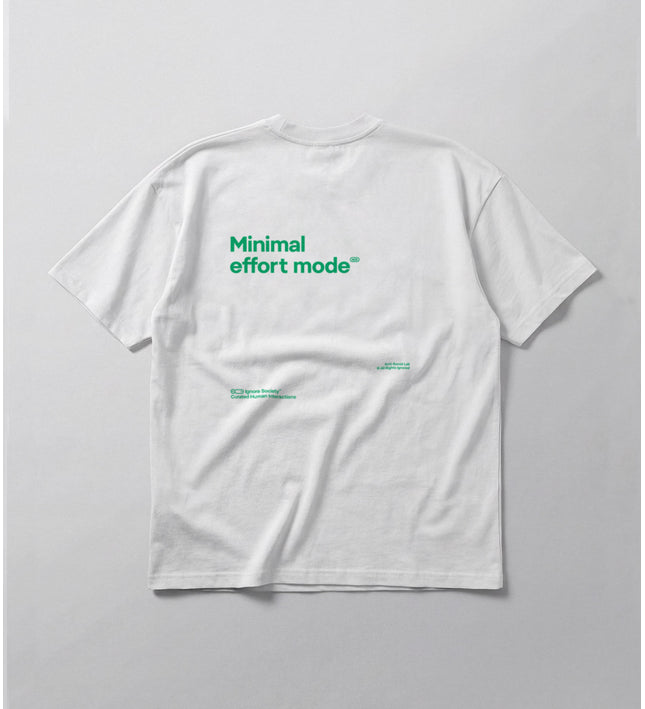 White t-shirt with green text 'Minimal effort mode' on a light gray background