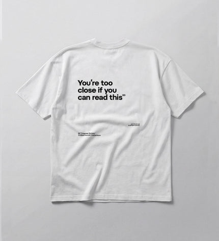 White t-shirt with black text on a light gray background