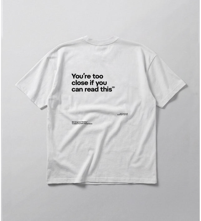 White t-shirt with black text on a light gray background