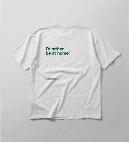 White t-shirt with text 'I'd rather be at home' on a light gray background