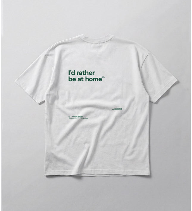 White t-shirt with text 'I'd rather be at home' on a light gray background