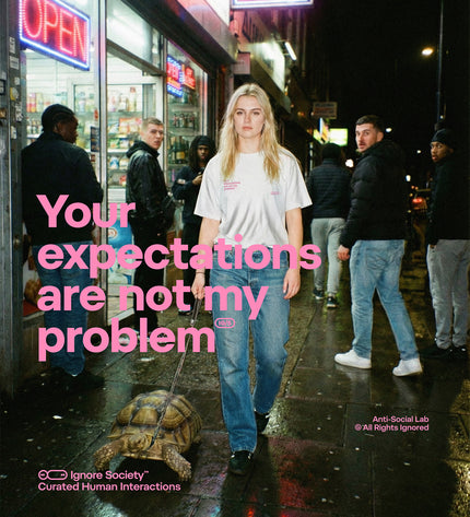 Person walking a tortoise on a leash with text 'Your expectations are not my problem' in an urban setting.