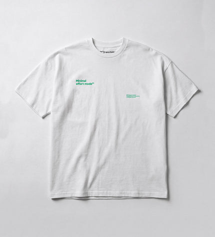 White t-shirt with green text on a light gray background