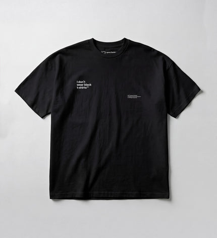 Black t-shirt with white text on a light gray background