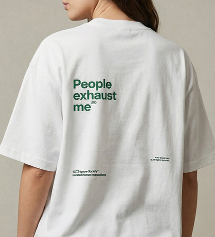 White t-shirt with green text on the back, worn by a person against a neutral background